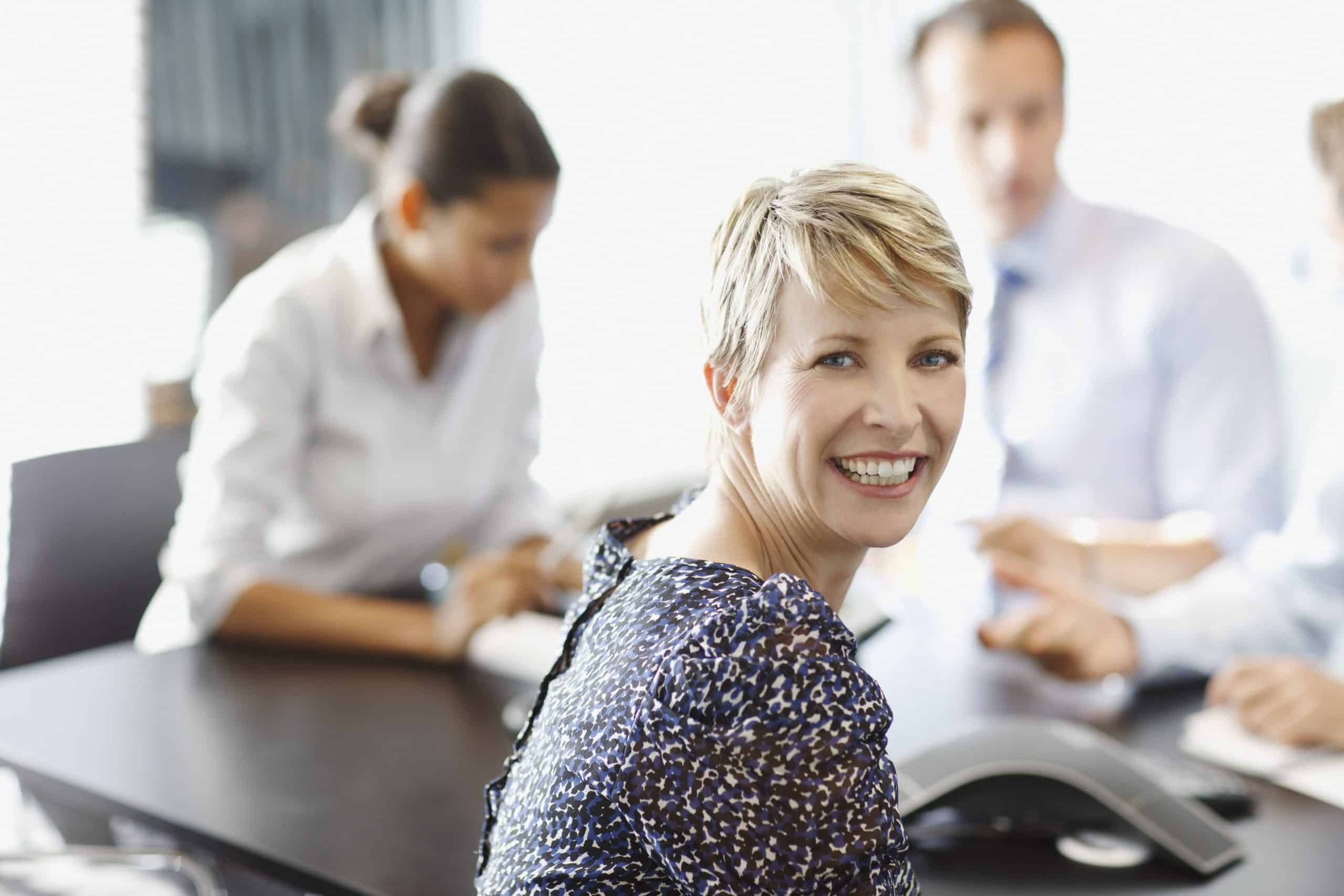 Businesswoman smiling at conference table