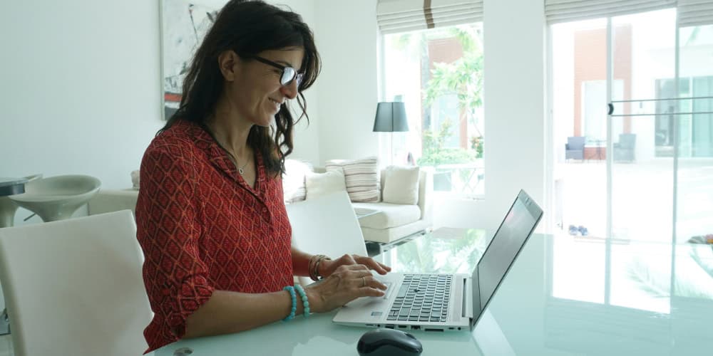 Person working from home to accompany blog article: How hybrid working impacts your performance management platform